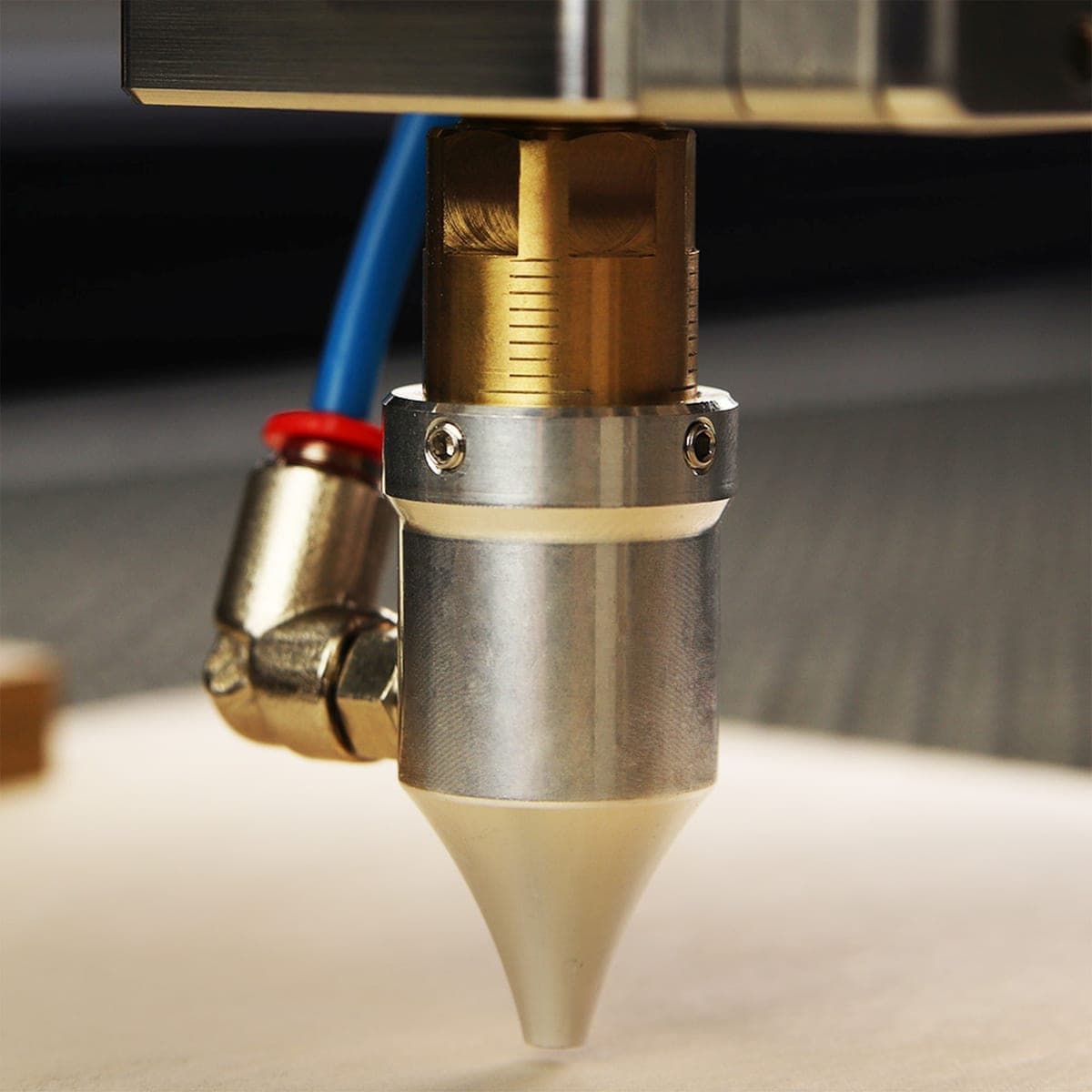 Close crop of a 3D printer hotend and the tip of its nozzle