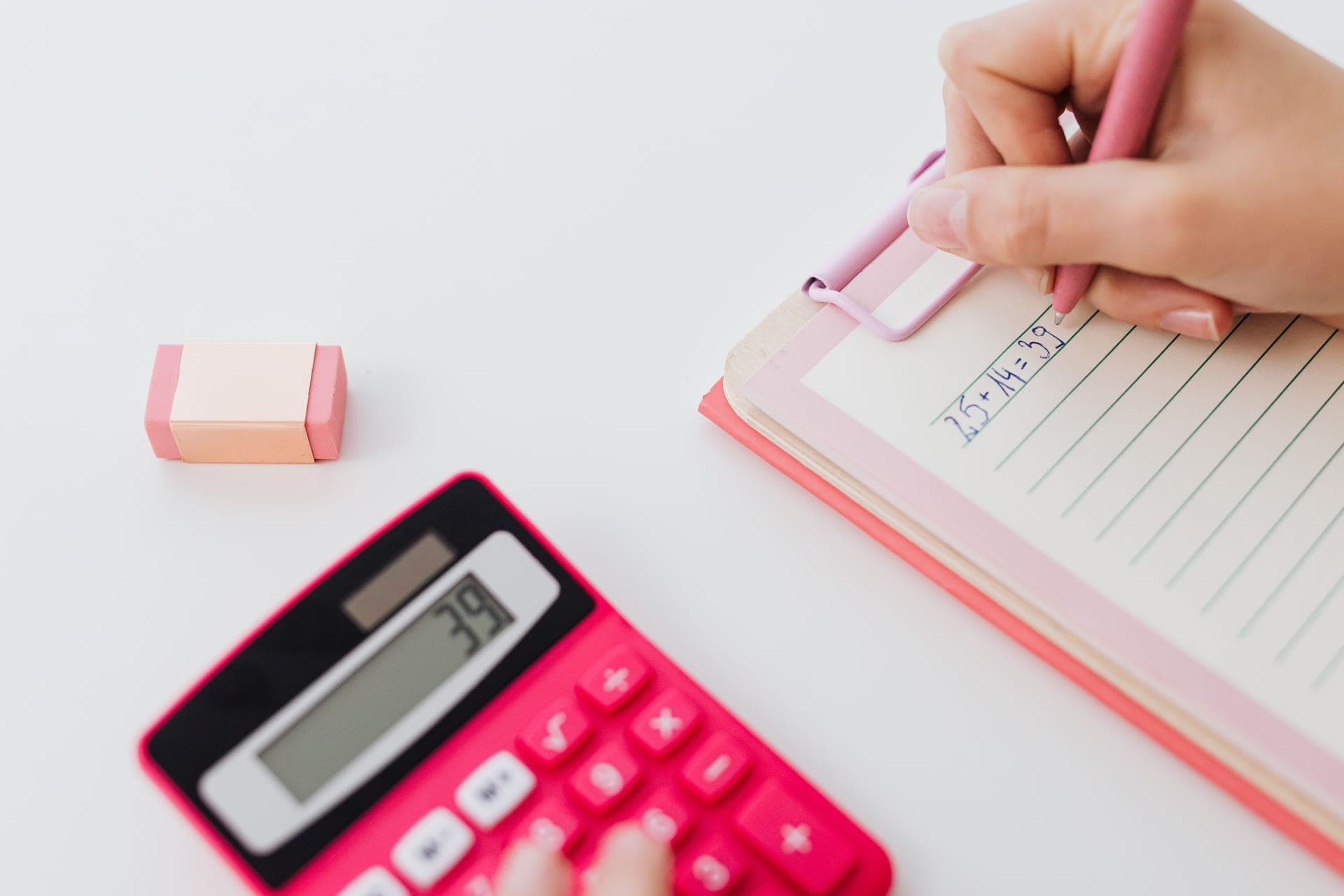 A calculator and notes on a workbench