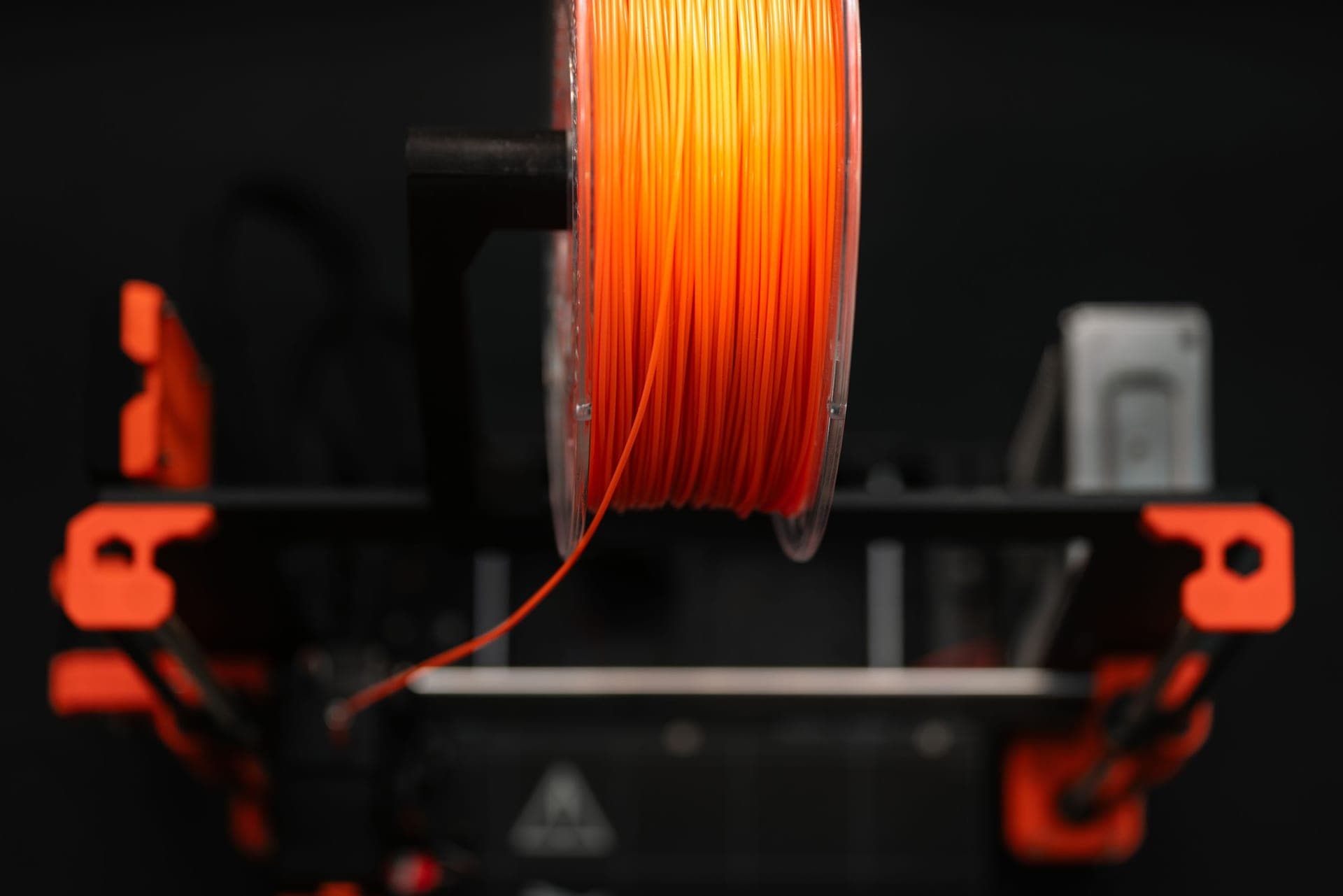 A translucent PETG spool next to a printed functional part